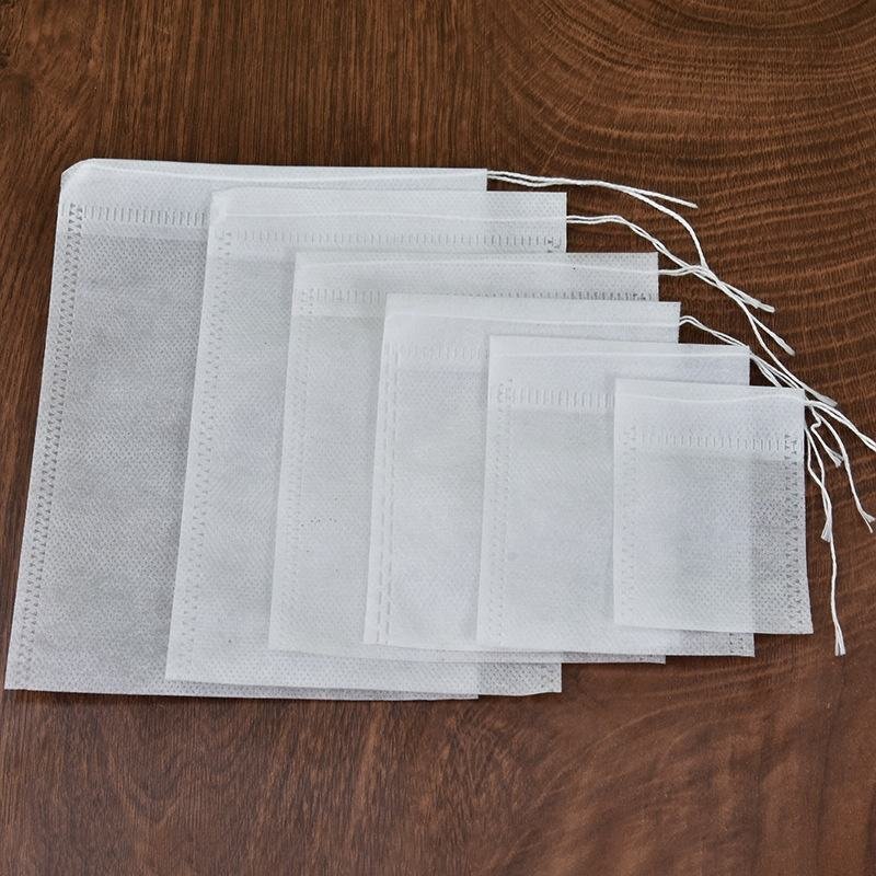 White non-woven drawstring sachet bags in multiple sizes