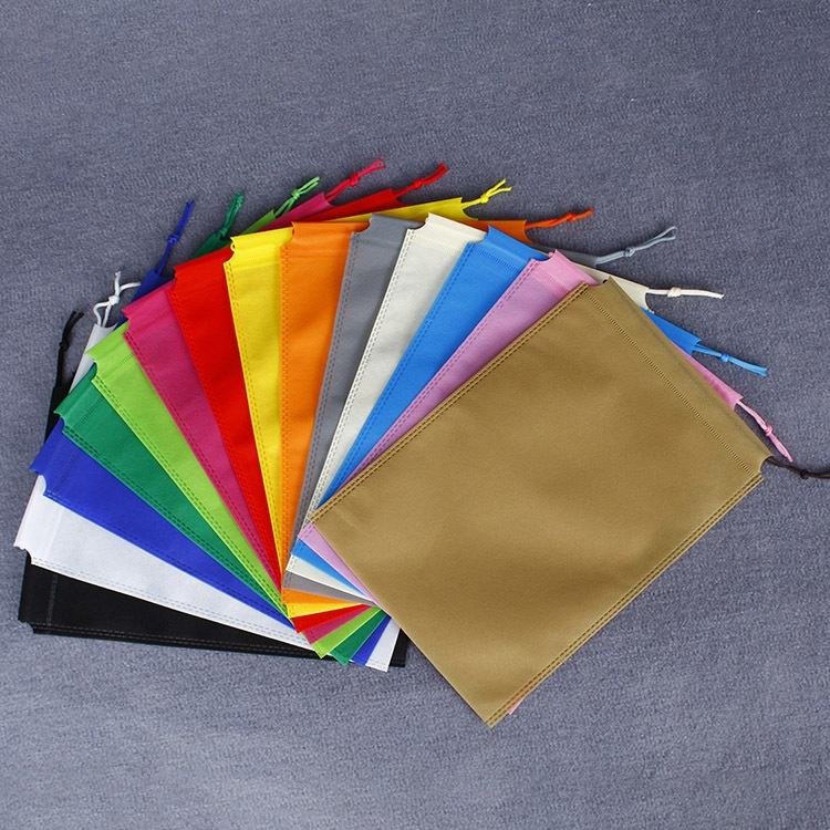 Assorted non-woven drawstring pouches in various colors